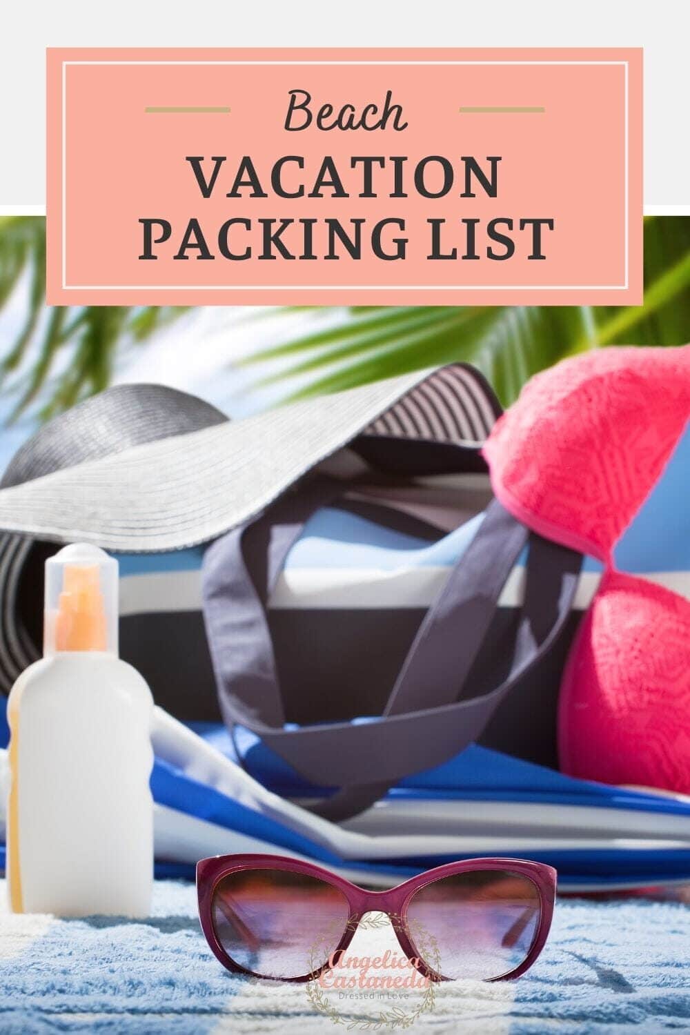 Pink sun glasses, white bottle, blue and white beach bag, navy blue and white sun hat and pink bathing suit top on a blue and white towel perfect for a beach vacation packing list.